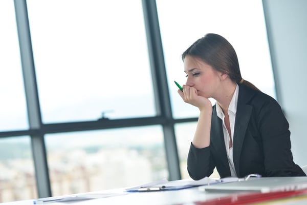 woman stares into distance at work