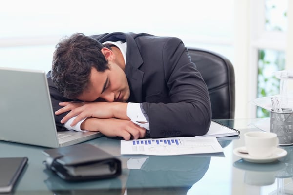 Man at work with head in hands, having a mini-breakdown